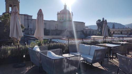 a patio with tables and chairs and umbrellas at Nukari Quinta Boutique in Jala