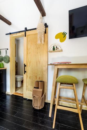 a room with a door and a table and a stool at The Herwood Inn in Woodstock