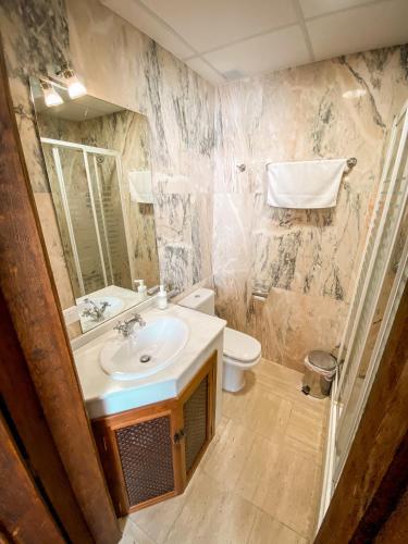 a bathroom with a sink and a toilet at La Colegiata De Ronda in Ronda