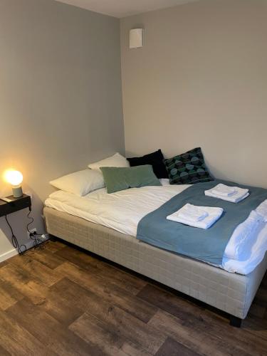 a bed with two towels on it in a bedroom at Central Studio Apartment in Stavanger