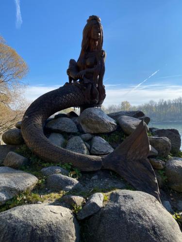 a statue of a mermaid sitting on some rocks at Appartement Gabriela ACHTUNG nur Feriengäste willkommen,es ist keine Arbeiterunterkunft in Obernzell
