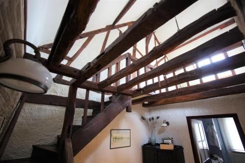 a room with a staircase with wooden beams at Maison Marcks Champagne in Ay