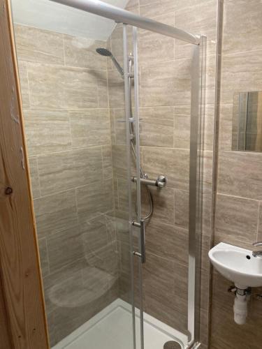a bathroom with a shower and a sink at White house in Birmingham