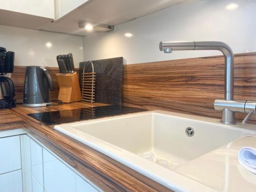 a kitchen sink with a faucet on a counter at Studio Inselblick für 2 mit Traumpanorama in Schliersee