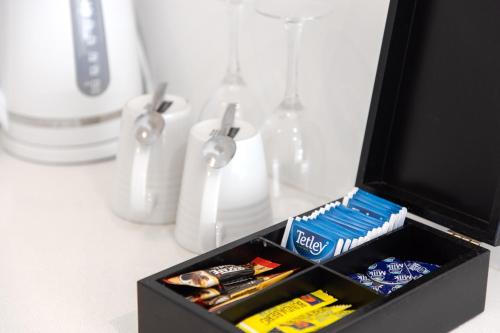 a black box filled with toothpaste and toothbrushes at 10 Hastings Street Motel in Noosa Heads