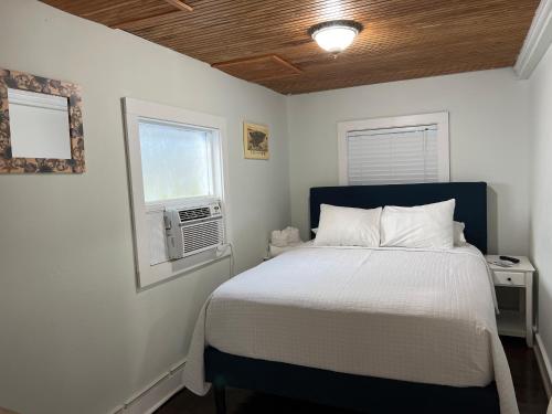 a bedroom with a bed and a window at The Garden House - Adult Only in Key West