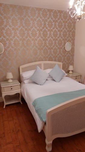a bedroom with a white bed with two night stands at Kilronan Holiday Homes in Kilronan