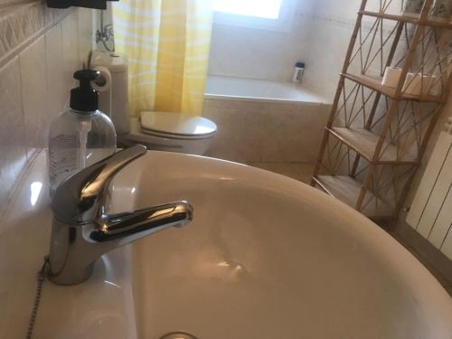 a bathroom with a sink with a soap dispenser on it at Casas Encinares in Narrillos de San Leonardo
