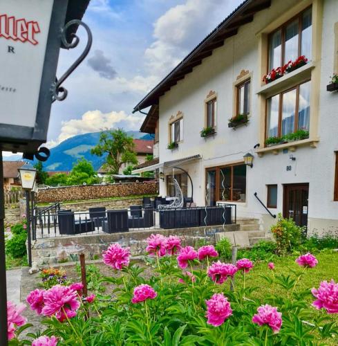 a building with pink flowers in front of it at Gasthof Barlida in Lainach