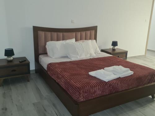 a bedroom with a bed with two towels on it at Eva Luxury Villa in Lachi