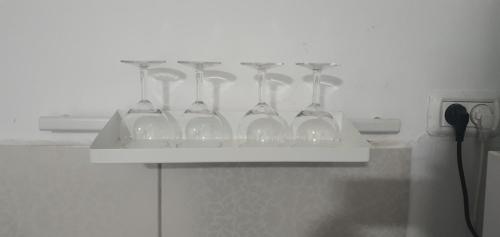 a white shelf with wine glasses on it at kinneret love sounds in Migdal