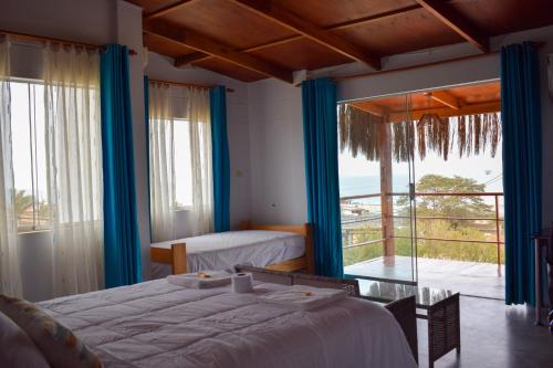 a bedroom with a bed and a view of the ocean at Mangata in Lobitos