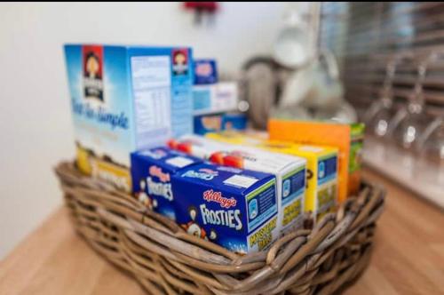 a basket filled with toys on top of a table at The Studio Christchurch B&B Luxury Garden Room in Christchurch