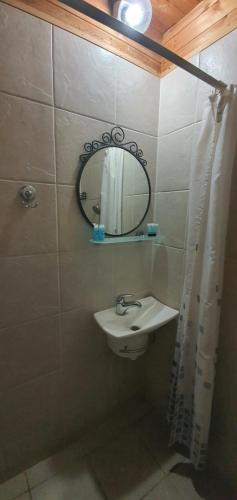 a bathroom with a sink and a mirror at kinneret love sounds in Migdal