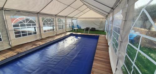 a swimming pool inside of a tent with a swimming pool at kinneret love sounds in Migdal