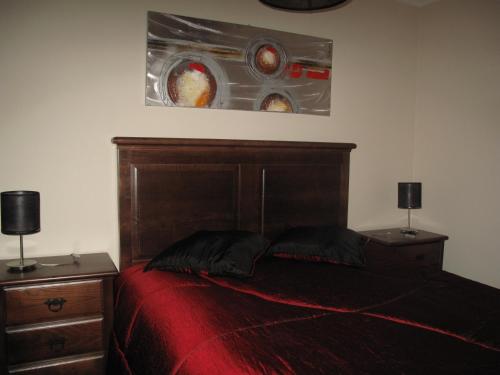 a bedroom with a bed with a red comforter at Cantinho da Estrela in Seia