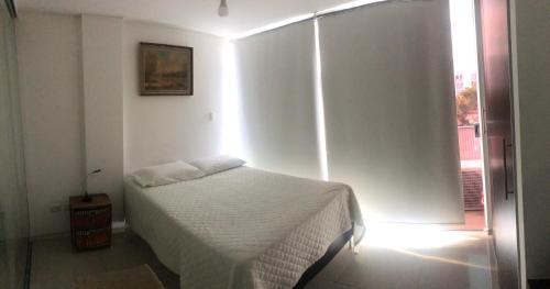 En eller flere senge i et værelse på Depto Equipe