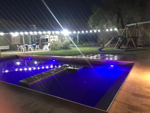Una piscina de noche con luces azules en Quinta El Molino, en San Pedro