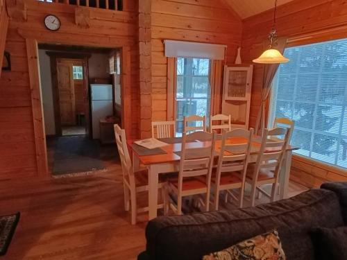 a dining room and living room with a table and chairs at Costa Villa in Tahkovuori