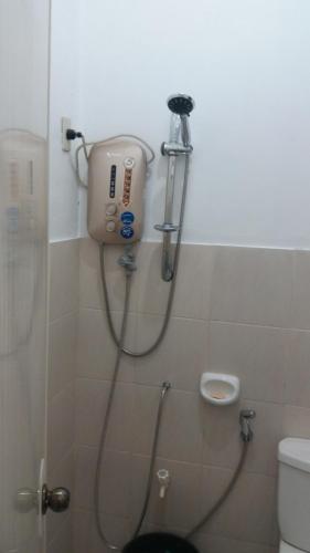 a shower in a bathroom with a toilet at RGR CAMIGUIN TRAVEL TOUR SERVICES AND PENSION HOUSE in Mambajao
