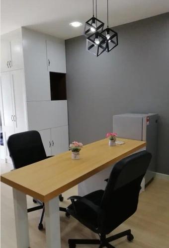 an office with a wooden table and two chairs at Cozy Studio house /Soho Unit Near Kampar Utar in Kampar