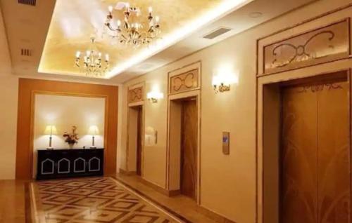 a hallway of a hotel with a chandelier at Cozy Studio house /Soho Unit Near Kampar Utar in Kampar