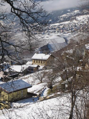 a building on a snowy hill with snow on the ground at La Grande Maison in Savièse