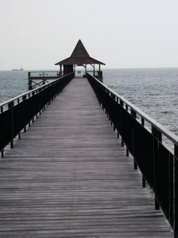 a wooden pier with a gazebo on the water at Nongsa Village Peaceful Villa in private beach Resort in Nongsa