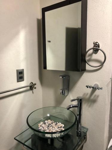 a glass sink in a bathroom with a mirror at Loft Bonhomia with parking 7min to downtown in Guanajuato
