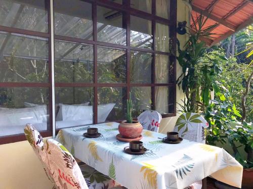 a table in a conservatory with a table with a table cloth at Ekman Garden Resort in Sichon