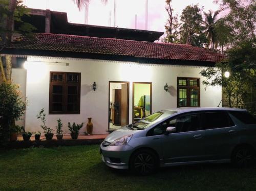 a car parked in front of a house at Hotel La Felicita in Mirissa