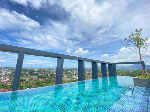 a swimming pool on the roof of a building at Prime Park Hotel & Convention Lombok in Mataram