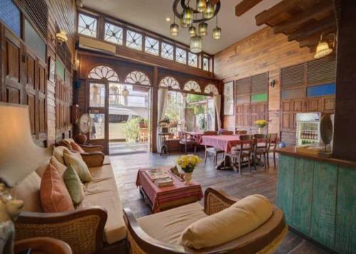 a living room filled with furniture and a large window at Rustic River Boutique in Chiang Mai