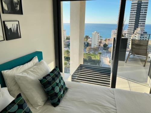 a bedroom with a bed and a view of the ocean at Sea View Apartment Arenal Beach Calpe in Calpe