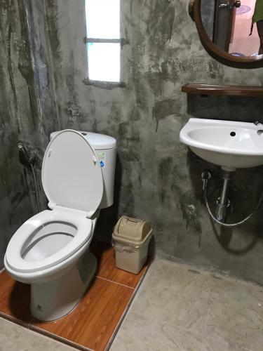 a bathroom with a toilet and a sink at Hippy Hut Koh Chang in Ko Chang
