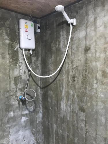 a hose is hooked up to a shower in a room at Hippy Hut Koh Chang in Ko Chang