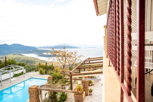 a view from the balcony of a house with a swimming pool at Lagou Raxi Country Hotel in Lafkos