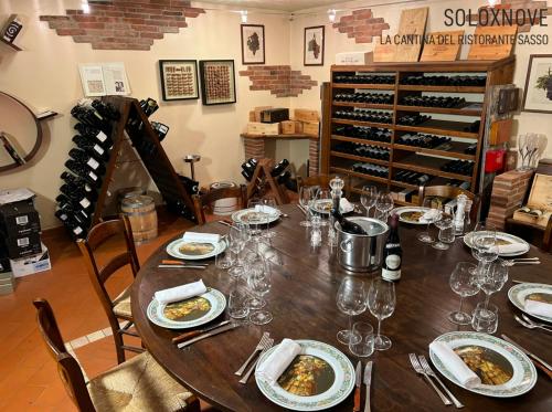 a table with plates of food and wine glasses at Hotel Ristorante SASSO in Bovolone