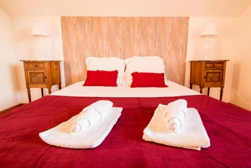 a bedroom with a large bed with towels on it at Nouveau - La Parenthèse in Wingersheim