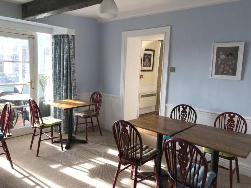 a dining room with two tables and chairs and a window at Lawrenny Lodge in Barmouth