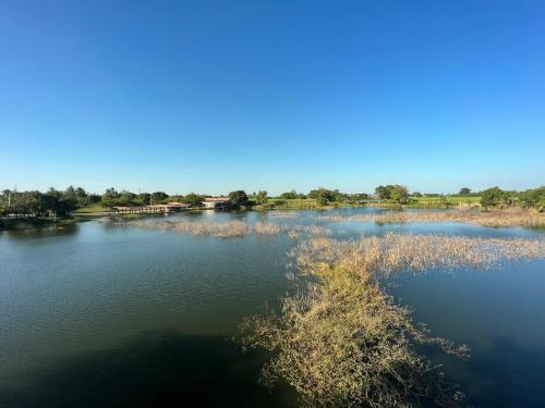 a view of a body of water with trees in the background at ทุ่งดินดำ Farm Stay in Ban Kho Wang