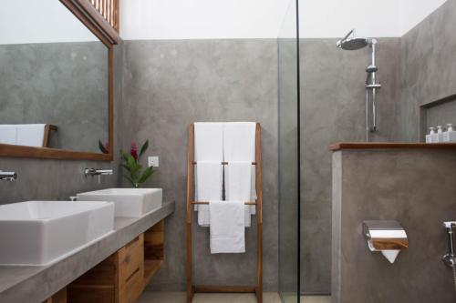 a bathroom with a sink and a shower at Ginger Palm Villa in Hiriketiya