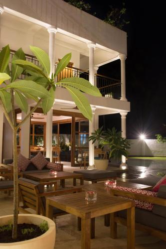 a house with a table and a palm tree at Ginger Palm Villa in Hiriketiya