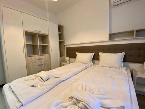 a bedroom with two beds with towels on them at The Green Paradise Apartments in Primorsko