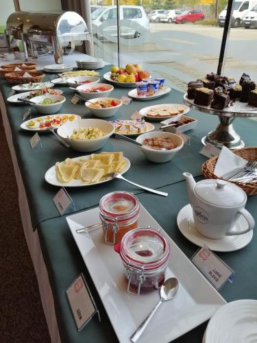 a long table with many plates of food on it at Hotel Rubin in Łódź