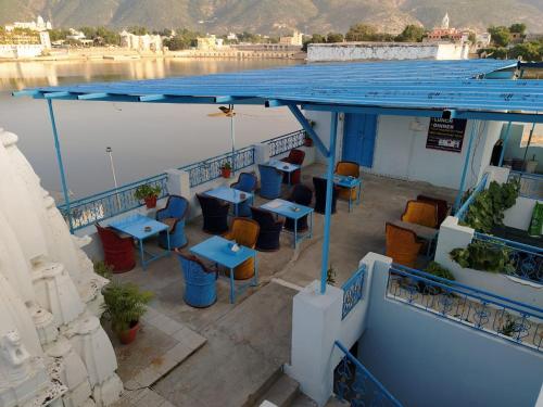 a deck of a boat with tables and chairs at Hotel Bharatpur Palace in Pushkar