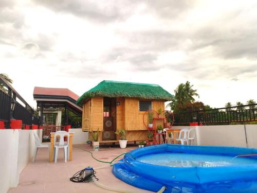 a small house with a hot tub on a patio at RB Baruiz "Hideaway" Inn - Cebu South in Cebu City