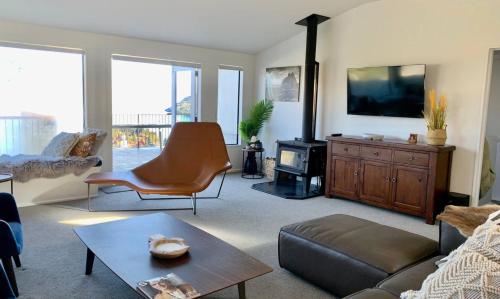 a living room with a couch and a tv at Lakeview Oasis in Queenstown