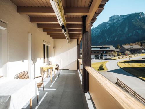 a balcony with a table and chairs and a view of a mountain at Gästehaus Manuela Puchmayr in Mellau