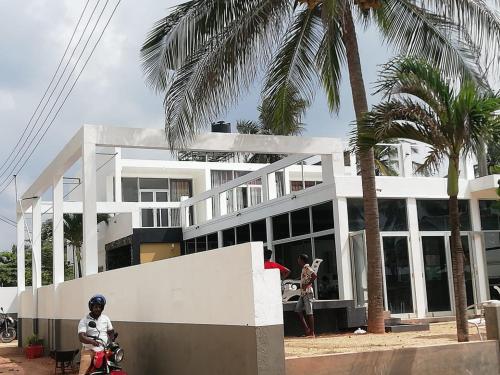 a man riding a motorcycle in front of a building at Saara Beach Hotel in Marawila